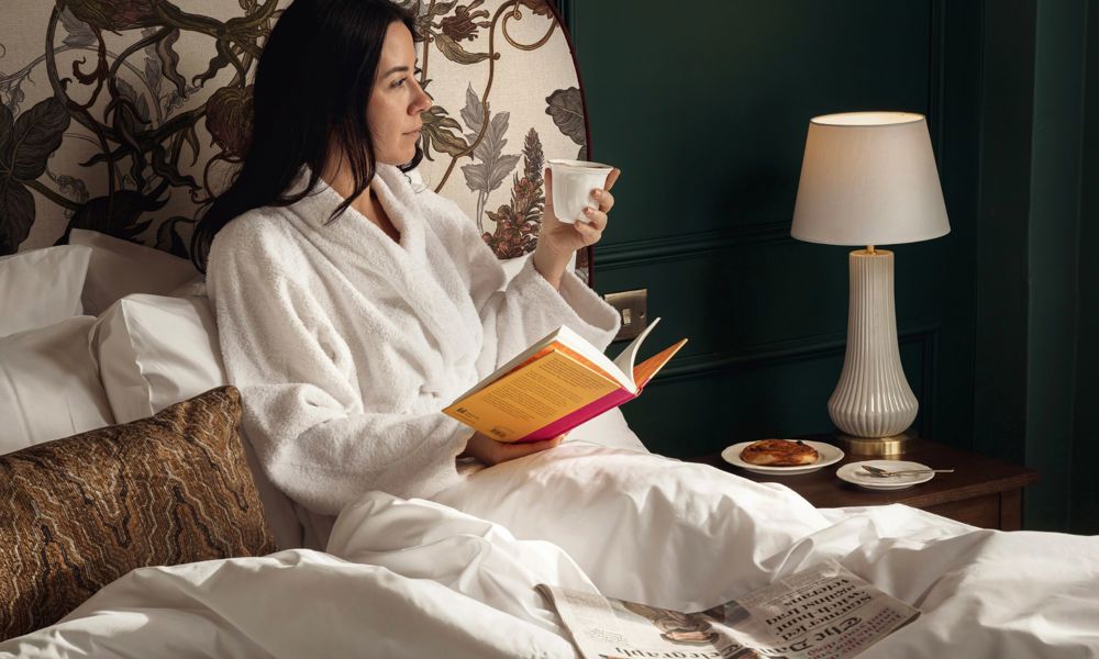 Francis Hotel Bath model reading in bed